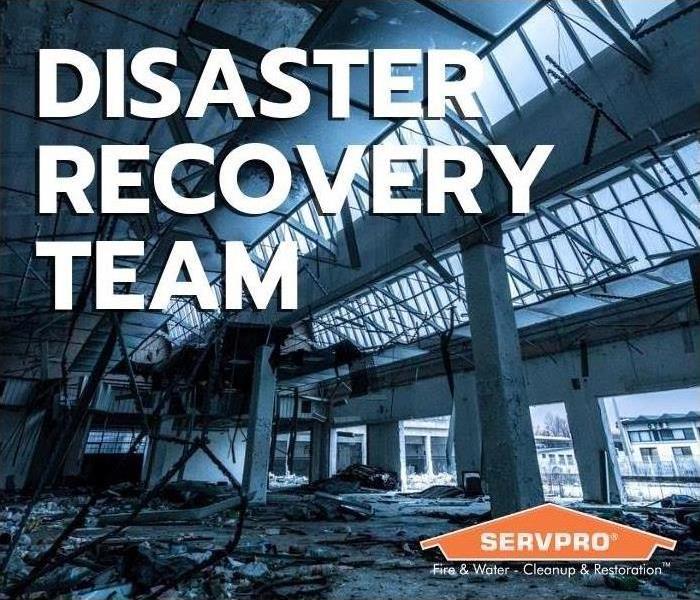 Inside of damaged commercial bulding with debris all over the ground, "disaster recovery team" top left, SERVPRO logo right